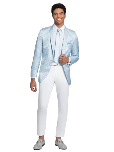 Young man standing in an Aries Wedgewood Paisley jacket with white pants and shoes